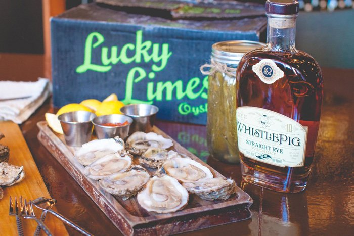 oysters on half shell with whiskey bottle