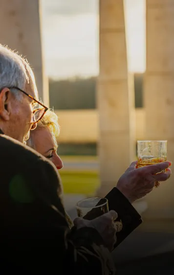 a man and a woman holding a glass of wine