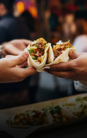 a group of people holding food in their hands