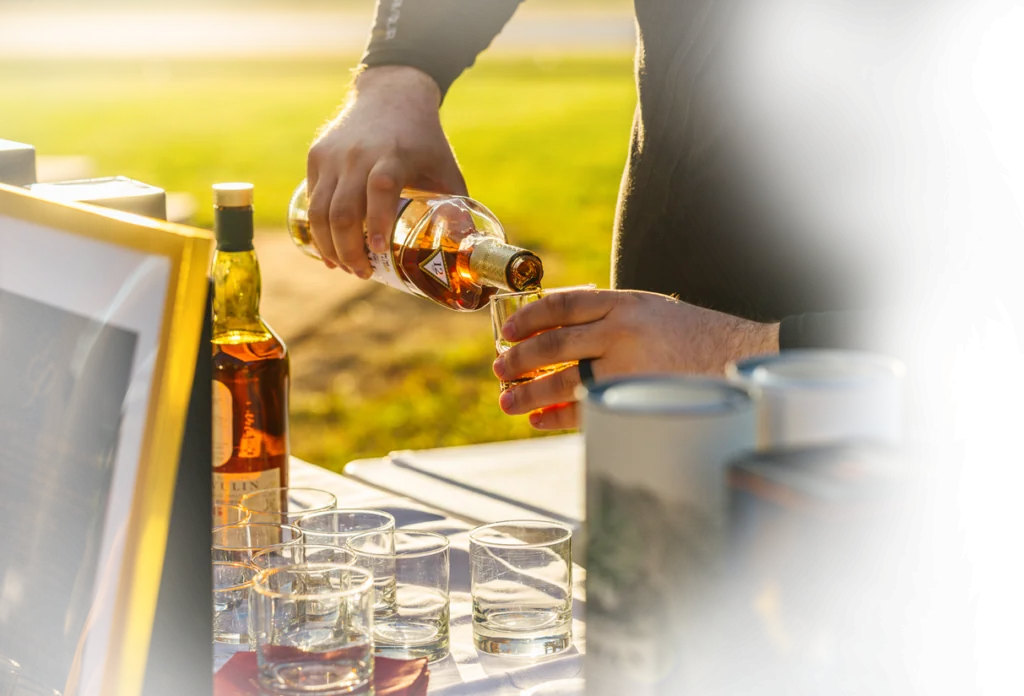 a man pouring a glass of wine at a table