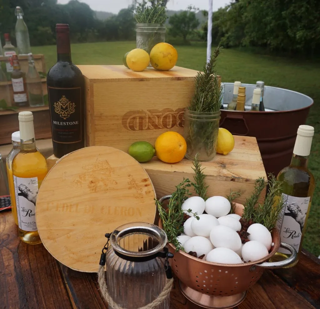 a wooden table topped with lots of bottles of wine