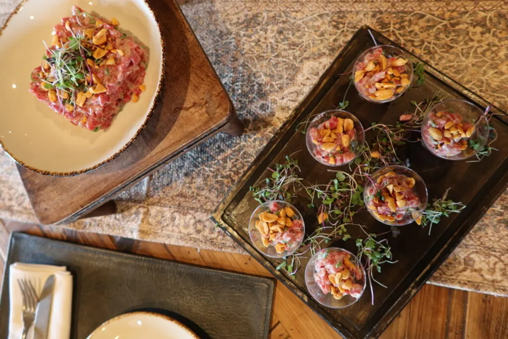 a table topped with plates and bowls of food