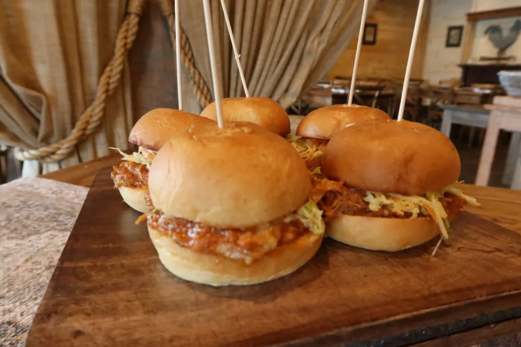 a couple of sandwiches sitting on top of a wooden table