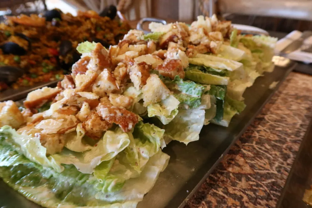 lettuce and chicken salad on a metal tray