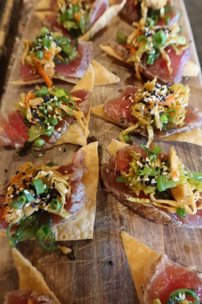 a wooden cutting board topped with lots of food