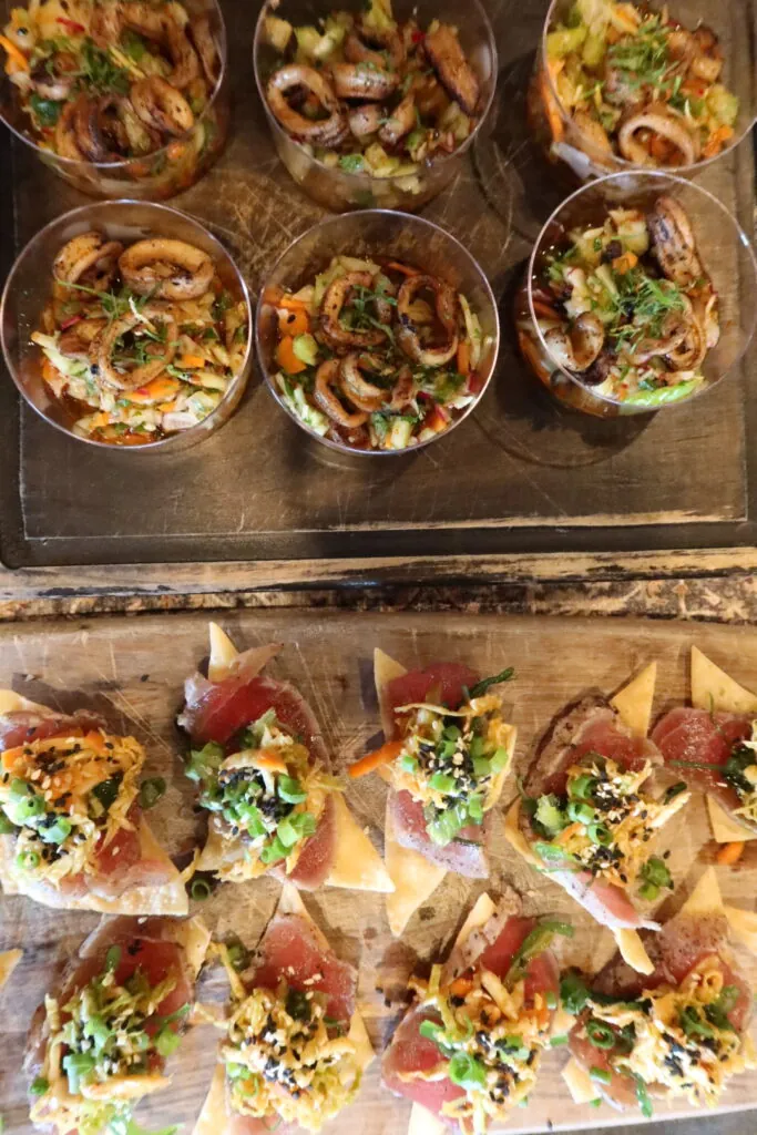 a table topped with trays of different types of food